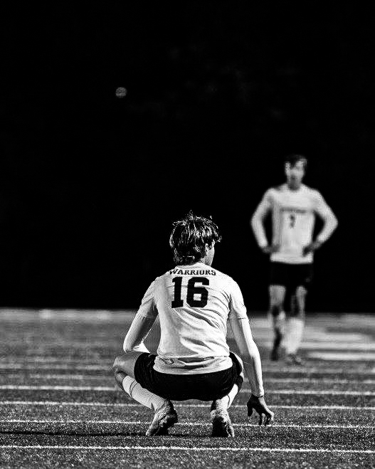 Black and white player #16 crouching