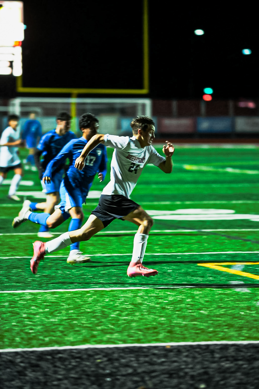 Night soccer player #24 sprinting